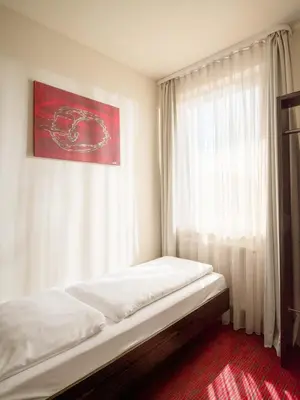 Ein Bett oder Betten in einem Zimmer der Unterkunft Hotel Speyer am Technik Museum