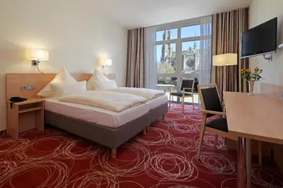 Ein Bett oder Betten in einem Zimmer der Unterkunft Hotel Löwengarten
