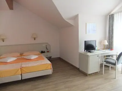 Ein Bett oder Betten in einem Zimmer der Unterkunft Hotel Garni Classico