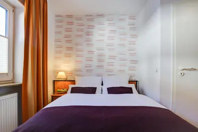 Ein Bett oder Betten in einem Zimmer der Unterkunft Rhein Neckar Hotel 24h Self Check-in