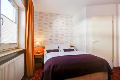 Ein Bett oder Betten in einem Zimmer der Unterkunft Rhein Neckar Hotel 24h Self Check-in