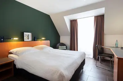 Ein Bett oder Betten in einem Zimmer der Unterkunft ACHAT Hotel Heppenheim