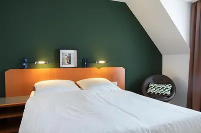 Ein Bett oder Betten in einem Zimmer der Unterkunft ACHAT Hotel Heppenheim