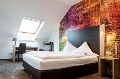 Ein Bett oder Betten in einem Zimmer der Unterkunft Hotel Beim Schupi Karlsruhe