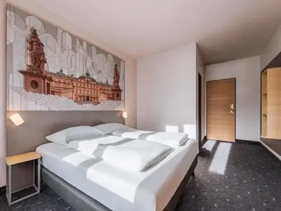 Ein Bett oder Betten in einem Zimmer der Unterkunft B&B HOTEL Rastatt