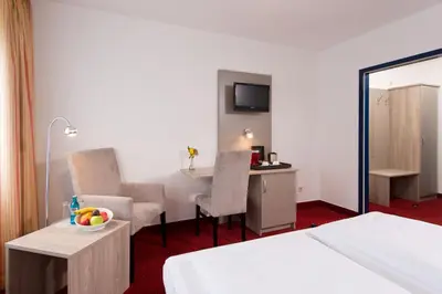 Ein Bett oder Betten in einem Zimmer der Unterkunft ACHAT Hotel Frankenthal in der Pfalz