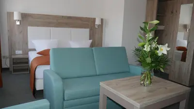 Ein Bett oder Betten in einem Zimmer der Unterkunft Komfort Hotel Ludwigsburg