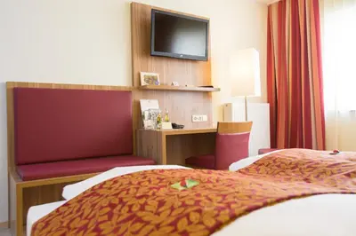 Ein Bett oder Betten in einem Zimmer der Unterkunft Pfalzhotel Asselheim