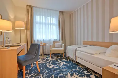 Ein Bett oder Betten in einem Zimmer der Unterkunft Schlosshotel Karlsruhe