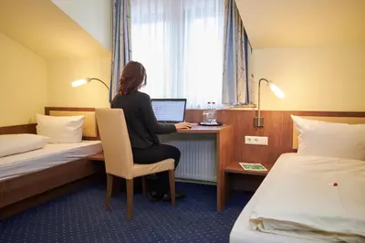 Ein Bett oder Betten in einem Zimmer der Unterkunft Flair Hotel Landgasthof Roger