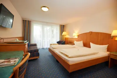 Ein Bett oder Betten in einem Zimmer der Unterkunft Flair Hotel Landgasthof Roger
