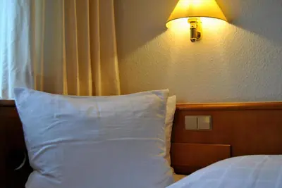 Ein Bett oder Betten in einem Zimmer der Unterkunft Hotel Kurpfalzstuben