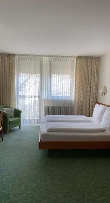 Ein Bett oder Betten in einem Zimmer der Unterkunft Hotel Kurpfalzstuben