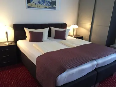 Ein Bett oder Betten in einem Zimmer der Unterkunft Wincent Hotel GmbH