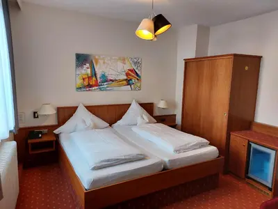 Ein Bett oder Betten in einem Zimmer der Unterkunft Hotel Garni 