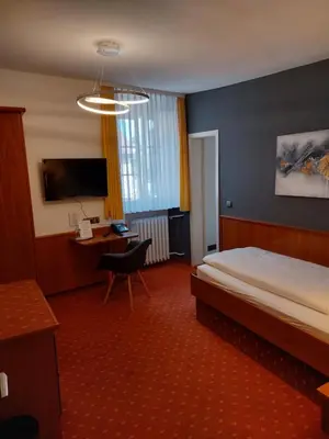 Ein Bett oder Betten in einem Zimmer der Unterkunft Hotel Garni 