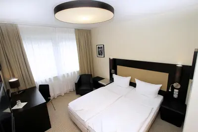 Ein Bett oder Betten in einem Zimmer der Unterkunft Karlstor Gästehaus
