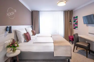 Ein Bett oder Betten in einem Zimmer der Unterkunft Adler Landhotel