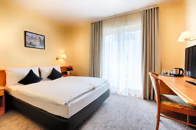 Ein Bett oder Betten in einem Zimmer der Unterkunft ACHAT Hotel Bad Dürkheim