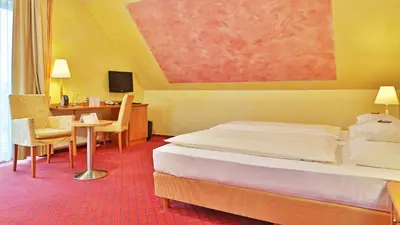 Ein Bett oder Betten in einem Zimmer der Unterkunft Businesshotel HEILBRONN- Biberach