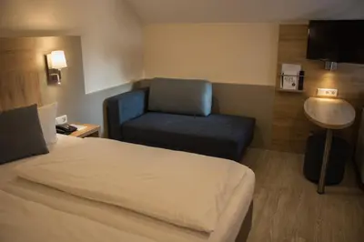 Ein Bett oder Betten in einem Zimmer der Unterkunft Hotel Rosenbusch