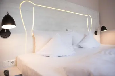 Ein Bett oder Betten in einem Zimmer der Unterkunft Parkhotel Schillerhain
