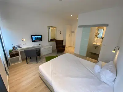 Ein Bett oder Betten in einem Zimmer der Unterkunft Hotel Barbarossa Karlsruhe Stadtmitte
