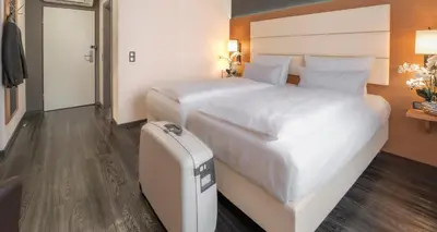 Ein Bett oder Betten in einem Zimmer der Unterkunft PLAZA INN Heilbronn