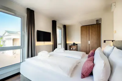 Ein Bett oder Betten in einem Zimmer der Unterkunft Welcome Hotel Darmstadt City Center