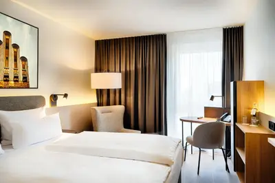 Ein Bett oder Betten in einem Zimmer der Unterkunft Welcome Hotel Darmstadt City Center