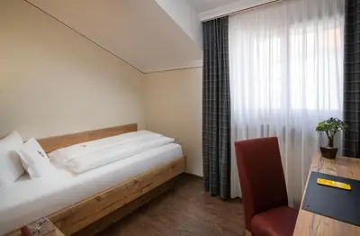 Ein Bett oder Betten in einem Zimmer der Unterkunft Ringhotel Winzerhof
