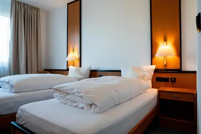 Ein Bett oder Betten in einem Zimmer der Unterkunft E&D Hotel Rodgau