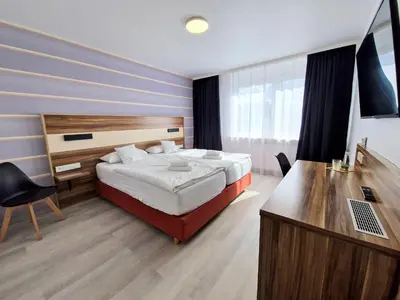 Ein Bett oder Betten in einem Zimmer der Unterkunft Hotel am Kurpark