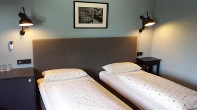 Ein Bett oder Betten in einem Zimmer der Unterkunft Hotel Henry