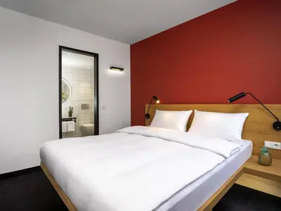 Ein Bett oder Betten in einem Zimmer der Unterkunft ibis Styles Darmstadt