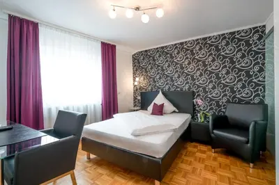 Ein Bett oder Betten in einem Zimmer der Unterkunft Hotel 'Zum Augarten'