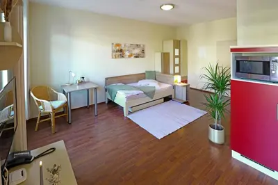Ein Bett oder Betten in einem Zimmer der Unterkunft Boardinghouse am Rosensee