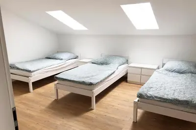 Ein Bett oder Betten in einem Zimmer der Unterkunft 4 Zimmer Ferienwohnung Egelsbach