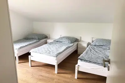 Ein Bett oder Betten in einem Zimmer der Unterkunft 4 Zimmer Ferienwohnung Egelsbach