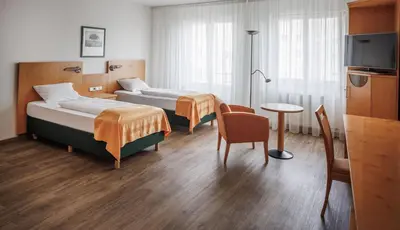 Ein Bett oder Betten in einem Zimmer der Unterkunft Ariva Boardinghouse Platanenhof