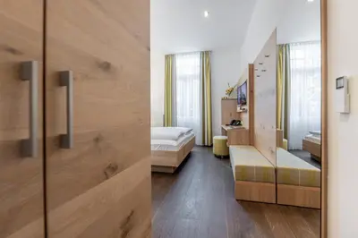 Ein Bett oder Betten in einem Zimmer der Unterkunft Villa Benz Hotel garni