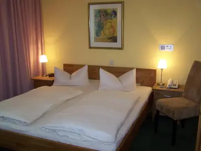 Ein Bett oder Betten in einem Zimmer der Unterkunft Hotel Am Stiftsberg