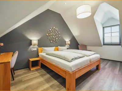 Ein Bett oder Betten in einem Zimmer der Unterkunft Hotel Landlust St. Martin