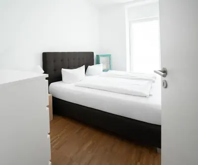 Ein Bett oder Betten in einem Zimmer der Unterkunft Prime Park Family Apartment Aschaffenburg