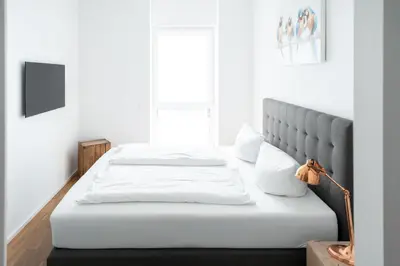 Ein Bett oder Betten in einem Zimmer der Unterkunft Prime Park Family Apartment Aschaffenburg
