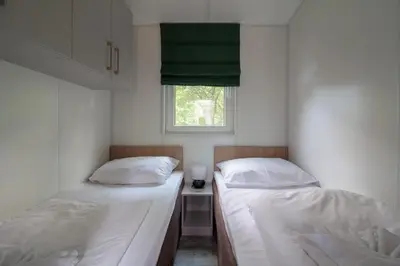 Ein Bett oder Betten in einem Zimmer der Unterkunft Iguana - Das Tiny Haus am Reptilienzoo Reptilium