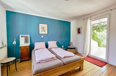 Ein Bett oder Betten in einem Zimmer der Unterkunft Ferienhaus CASA PI mit Gemeinschaftgarten