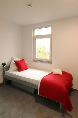 Ein Bett oder Betten in einem Zimmer der Unterkunft Boardinghouse - Alte Mühle