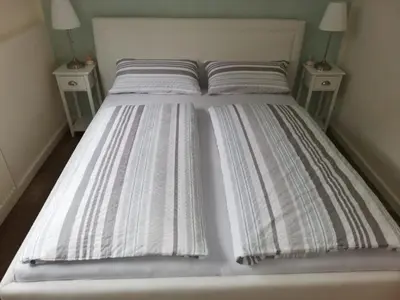 Ein Bett oder Betten in einem Zimmer der Unterkunft Gästehaus Becker