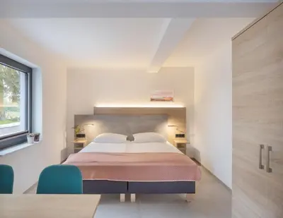 Ein Bett oder Betten in einem Zimmer der Unterkunft Ferienwohnungen Im Vogelgesang W5
